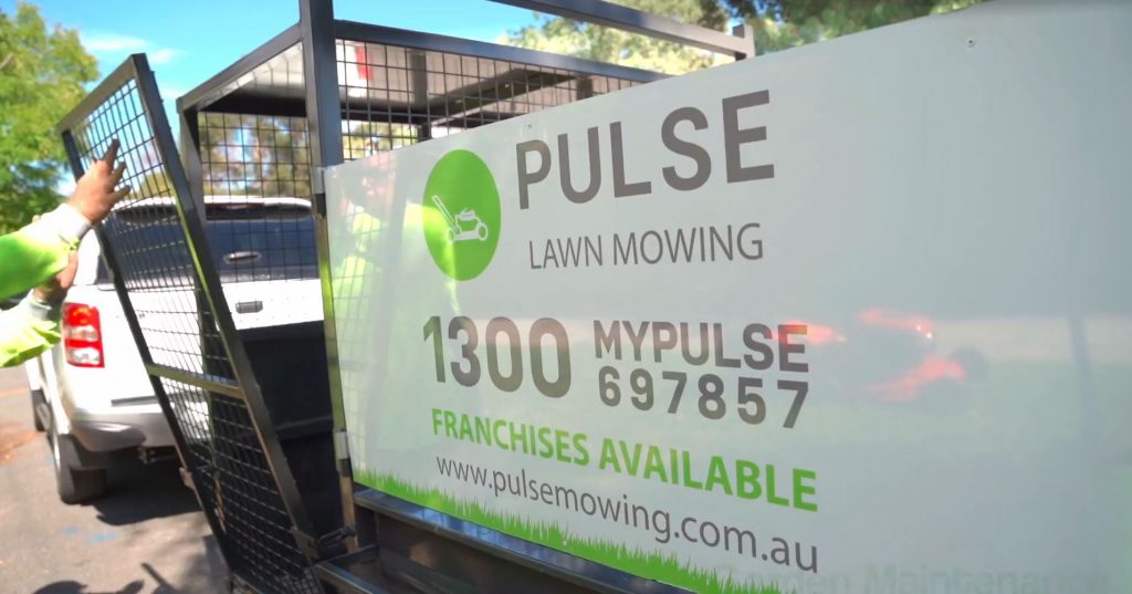 pulse mowing ute and trailer at a house